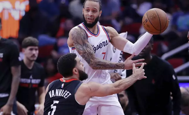 Los Angeles Clippers guard Amir Coffey (7) looks to pass the ball over Houston Rockets guard Fred VanVleet (5) during the first half of an Emirates NBA Cup basketball game Friday, Nov. 15, 2024, in Houston. (AP Photo/Michael Wyke)