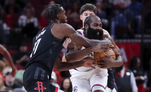 Houston Rockets forward Tari Eason, left, reaches in to force a jump ball with Los Angeles Clippers guard James Harden, front right, as Rockets guard Reed Sheppard, back right, looks on during the first half of an Emirates NBA Cup basketball game Friday, Nov. 15, 2024, in Houston. (AP Photo/Michael Wyke)