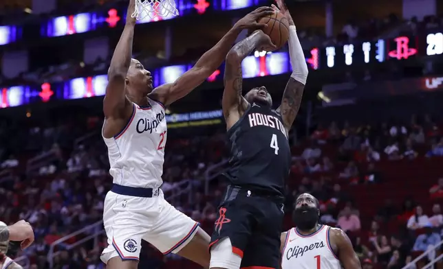 Los Angeles Clippers forward Kai Jones, left, blocks a shot-attempt by Houston Rockets guard Jalen Green (4) as Clippers guard James Harden watches during the first half of an Emirates NBA Cup basketball game Friday, Nov. 15, 2024, in Houston. (AP Photo/Michael Wyke)