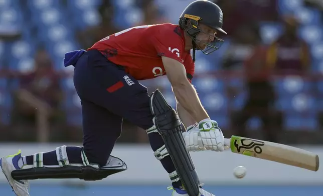 FILE - England's captain Jos Buttler plays a shot against West Indies during the fourth T20 cricket match at Daren Sammy National Cricket Stadium in Gros Islet, St. Lucia, on Nov. 16, 2024. (AP Photo/Ricardo Mazalan, File)