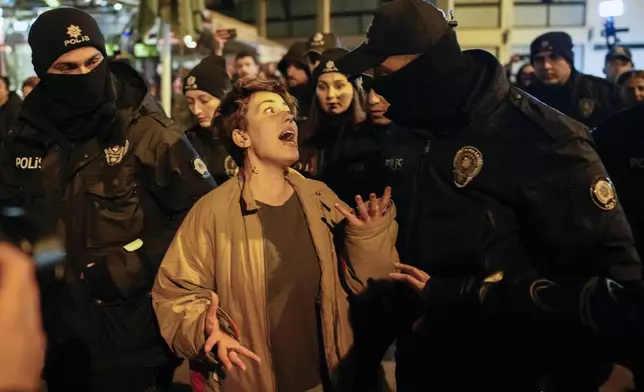 A women argues with a police officer during a protest marking the International Day for the Elimination of Violence Against Women, in Istanbul, Turkey, Monday, Nov. 25, 2024. (AP Photo/Emrah Gurel)