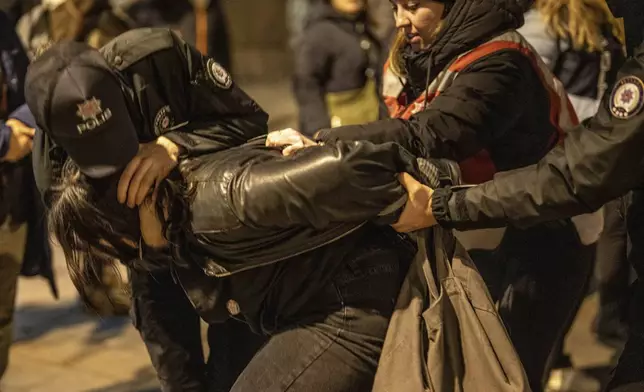 Turkish police detains a woman during a protest marking the International Day for the Elimination of Violence Against Women, in Istanbul, Turkey, Monday, Nov. 25, 2024. (AP Photo/Emrah Gurel)