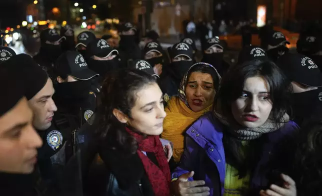 Women surrounded by police during a protest marking the International Day for the Elimination of Violence Against Women, in Istanbul, Turkey, Monday, Nov. 25, 2024. (AP Photo/Emrah Gurel)