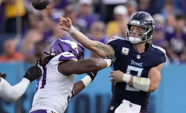 Tennessee Titans quarterback Will Levis (8) throws a pass as he is pressured by Minnesota Vikings linebacker Pat Jones II (91) during the second half of an NFL football game, Sunday, Nov. 17, 2024, in Nashville, Tenn. (AP Photo/George Walker IV)