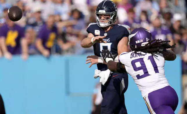 Tennessee Titans quarterback Will Levis (8) throws a pass as he is pressured by Minnesota Vikings linebacker Pat Jones II (91) during the first half of an NFL football game, Sunday, Nov. 17, 2024, in Nashville, Tenn. (AP Photo/George Walker IV)