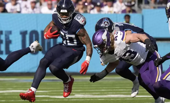 Tennessee Titans running back Tony Pollard (20) run from Minnesota Vikings linebacker Andrew Van Ginkel (43) during the first half of an NFL football game, Sunday, Nov. 17, 2024, in Nashville, Tenn. (AP Photo/George Walker IV)