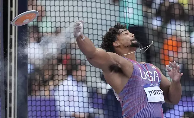 FILE - Sam Mattis, of the United States, competes during the men's discus throw qualification at the 2024 Summer Olympics, Aug. 5, 2024, in Saint-Denis, France. (AP Photo/Matthias Schrader, File)