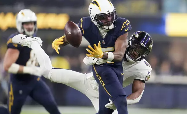 Baltimore Ravens cornerback Marlon Humphrey (44) breaks up a pass intended for Los Angeles Chargers wide receiver Joshua Palmer (5) during the second half of an NFL football game Monday, Nov. 25, 2024, in Inglewood, Calif. (AP Photo/Eric Thayer)