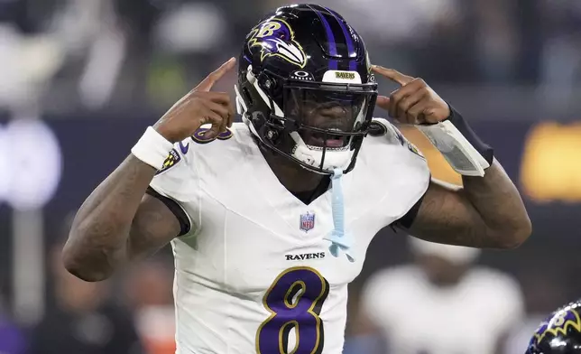 Baltimore Ravens quarterback Lamar Jackson (8) calls a play during the first half of an NFL football game against the Los Angeles Chargers, Monday, Nov. 25, 2024, in Inglewood, Calif. (AP Photo/Eric Thayer)