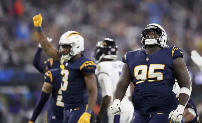 Los Angeles Chargers defensive tackle Poona Ford (95) celebrates after a defensive stop during the first half of an NFL football game against the Baltimore Ravens, Monday, Nov. 25, 2024, in Inglewood, Calif. (AP Photo/Eric Thayer)