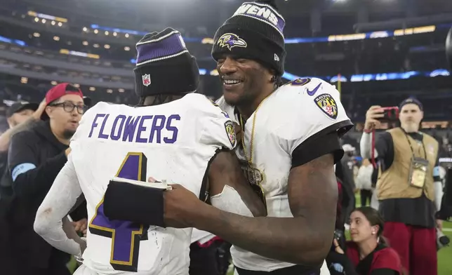 Baltimore Ravens quarterback Lamar Jackson, right, hugs wide receiver Zay Flowers after a win over the Los Angeles Chargers in an NFL football game Monday, Nov. 25, 2024, in Inglewood, Calif. (AP Photo/Eric Thayer)