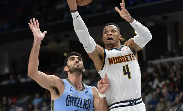 Denver Nuggets guard Russell Westbrook (4) shoots against Memphis Grizzlies forward Santi Aldama (7) in the second half of an Emirates NBA Cup basketball game Tuesday, Nov. 19, 2024, in Memphis, Tenn. (AP Photo/Brandon Dill)