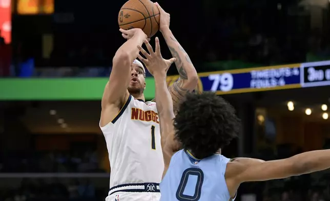 Denver Nuggets forward Michael Porter Jr. (1) shoots against Memphis Grizzlies forward Jaylen Wells (0) in the second half of an Emirates NBA Cup basketball game Tuesday, Nov. 19, 2024, in Memphis, Tenn. (AP Photo/Brandon Dill)