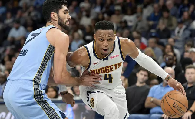 Denver Nuggets guard Russell Westbrook (4) handles the ball against Memphis Grizzlies forward Santi Aldama (7) in the second half of an Emirates NBA Cup basketball game Tuesday, Nov. 19, 2024, in Memphis, Tenn. (AP Photo/Brandon Dill)