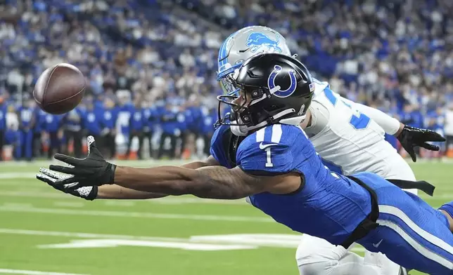 Indianapolis Colts wide receiver Josh Downs (1), defended by Detroit Lions cornerback Khalil Dorsey (30), is unable to catch a pass during the second half of an NFL football game, Sunday, Nov. 24, 2024, in Indianapolis. (AP Photo/Michael Conroy)