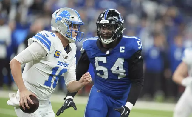 Indianapolis Colts defensive end Dayo Odeyingbo (54) chases Detroit Lions quarterback Jared Goff (16) during the second half of an NFL football game, Sunday, Nov. 24, 2024, in Indianapolis. (AP Photo/Michael Conroy)