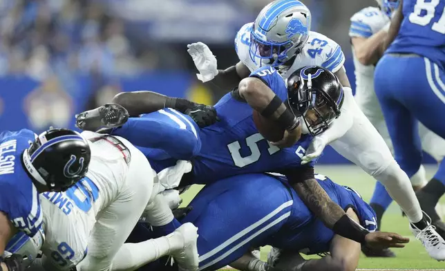 Indianapolis Colts quarterback Anthony Richardson (5) is tackled during the second half of an NFL football game against the Detroit Lions, Sunday, Nov. 24, 2024, in Indianapolis. (AP Photo/AJ Mast)