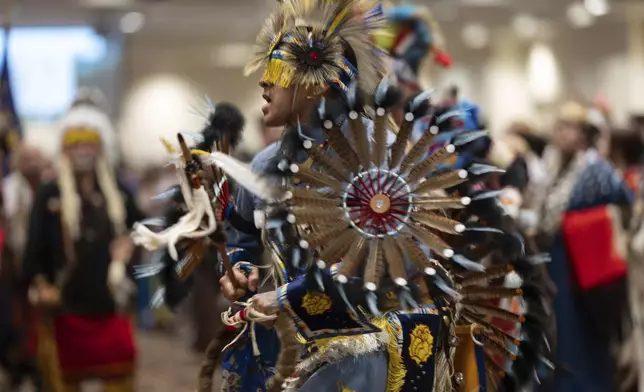 People dance during a powwow at Chinook Winds Casino Resort, Saturday, Nov. 16, 2024, in Lincoln City, Ore. (AP Photo/Jenny Kane)