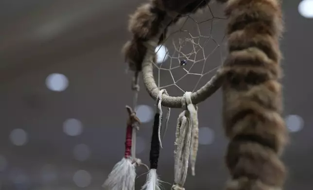 A dream catcher is seen on an eagle staff during a powwow at Chinook Winds Casino Resort, Saturday, Nov. 16, 2024, in Lincoln City, Ore. (AP Photo/Jenny Kane)