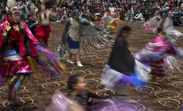 People dance in a powwow at Chinook Winds Casino Resort, Saturday, Nov. 16, 2024, in Lincoln City, Ore. (AP Photo/Jenny Kane)