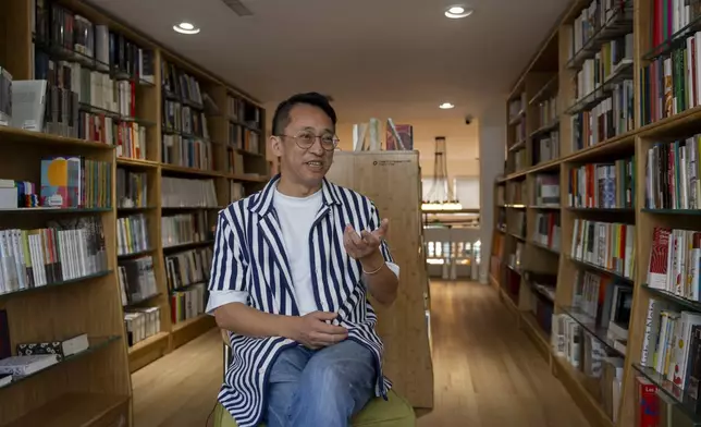 Yu Miao, owner of JF Books, speaks to The Associated Press in his bookstore in Washington, Thursday, Oct. 3, 2024. (AP Photo/Ben Curtis)