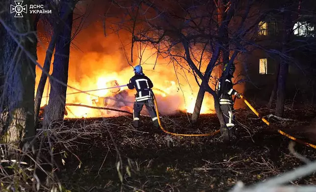 In this photo provided by the Ukrainian Emergency Service, firefighters extinguish the fire following a Russian rocket attack that hit a multi-storey apartment building in Sumy, Ukraine, Sunday, Nov. 17, 2024. (Ukrainian Emergency Service via AP)