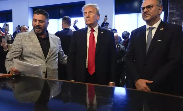 FILE - Republican presidential nominee former President Donald Trump, center, listens to Albert Abbas, owner of The Great Commoner, left, as Massad Boulos looks on during a visit to the cafe, Nov. 1, 2024, in Dearborn, Mich. (AP Photo/Julia Demaree Nikhinson, File)