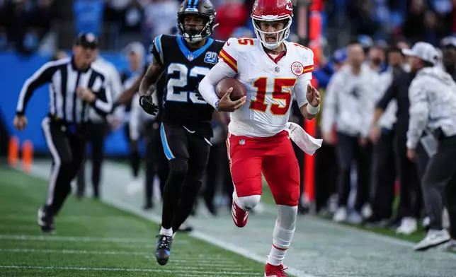 Kansas City Chiefs quarterback Patrick Mahomes (15) runs in overtime against the Carolina Panthers during an NFL football game, Sunday, Nov. 24, 2024, in Charlotte, N.C. (AP Photo/Jacob Kupferman)