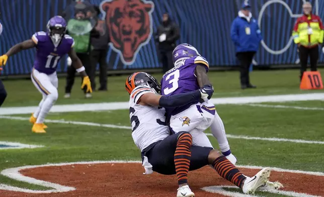 Minnesota Vikings wide receiver Jordan Addison (3) makes a touchdown catch as Chicago Bears safety Jonathan Owens tackles during the first half of an NFL football game Sunday, Nov. 24, 2024, in Chicago. (AP Photo/Charles Rex Arbogast)