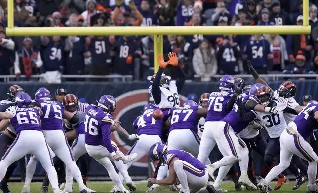 Minnesota Vikings place kicker Parker Romo (96) makes the game-wining field goal in overtime of an NFL football game against the Chicago Bears, Sunday, Nov. 24, 2024, in Chicago. (AP Photo/Charles Rex Arbogast)