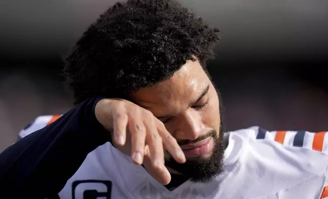 Chicago Bears quarterback Caleb Williams wipes sweat from his face on the sideline during the first half of an NFL football game against the Minnesota Vikings, Sunday, Nov. 24, 2024, in Chicago. (AP Photo/Erin Hooley)