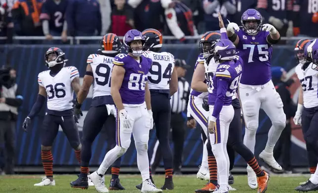 Minnesota Vikings place kicker Parker Romo (96) celebrates his game-wining field goal with teammates in overtime of an NFL football game against the Chicago Bears, Sunday, Nov. 24, 2024, in Chicago. (AP Photo/Charles Rex Arbogast)