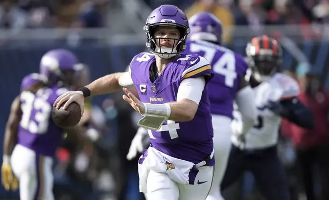 Minnesota Vikings quarterback Sam Darnold (14) throws a pass during the first half of an NFL football game against the Chicago Bears, Sunday, Nov. 24, 2024, in Chicago. (AP Photo/Charles Rex Arbogast)