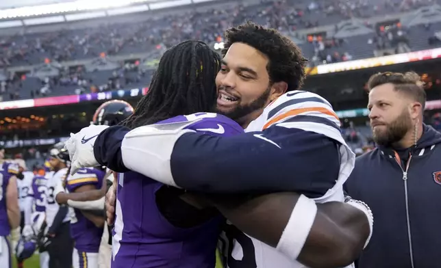 Chicago Bears quarterback Caleb Williams, right, hugs Minnesota Vikings linebacker Brian Asamoah II after an NFL football game Sunday, Nov. 24, 2024, in Chicago. (AP Photo/Erin Hooley)