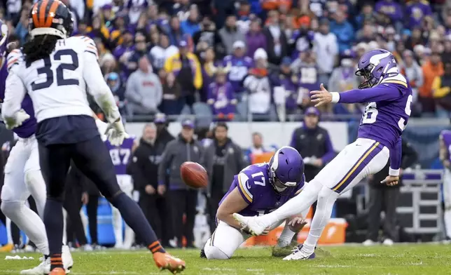 Minnesota Vikings place kicker Parker Romo, right, makes the game-wining field goal in overtime of an NFL football game against the Chicago Bears, Sunday, Nov. 24, 2024, in Chicago. (AP Photo/Erin Hooley)