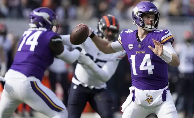 Minnesota Vikings quarterback Sam Darnold (14) throws a pass during the first half of an NFL football game against the Minnesota Vikings, Sunday, Nov. 24, 2024, in Chicago. (AP Photo/Charles Rex Arbogast)