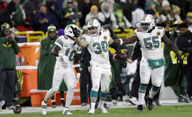 Miami Dolphins fullback Alec Ingold (30) reacts after running for a first down during the first half of an NFL football game against the Green Bay Packers Thursday, Nov. 28, 2024, in Green Bay, Wis. (AP Photo/Matt Ludtke)