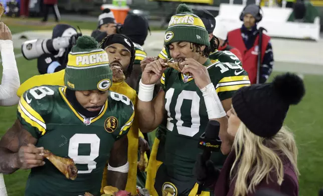 Green Bay Packers quarterback Jordan Love (10) eats a turkey leg after an NFL football game against the Miami Dolphins Thursday, Nov. 28, 2024, in Green Bay, Wis. (AP Photo/Matt Ludtke)