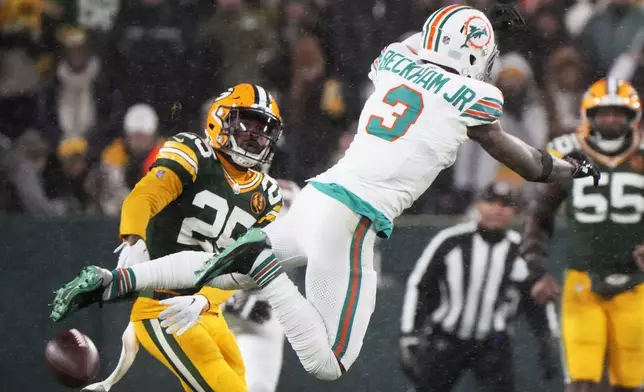 Green Bay Packers cornerback Keisean Nixon (25) breaks up a pass intended for Miami Dolphins wide receiver Odell Beckham Jr. (3) during the second half of an NFL football game Thursday, Nov. 28, 2024, in Green Bay, Wis. (AP Photo/Morry Gash)