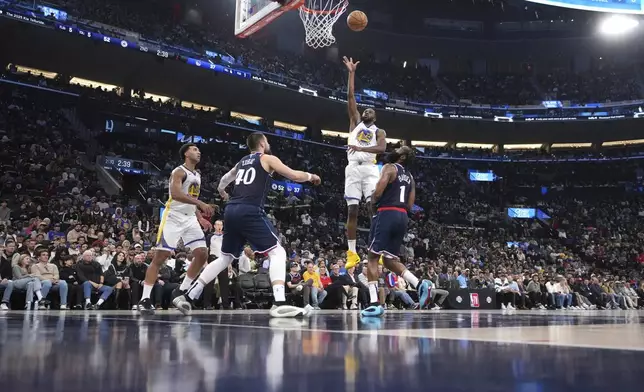 Golden State Warriors forward Andrew Wiggins (22) shoots as Los Angeles Clippers center Ivica Zubac (40) and guard James Harden (1) defend during the second half of an NBA basketball game, Monday, Nov. 18, 2024, in Inglewood, Calif. (AP Photo/Mark J. Terrill)