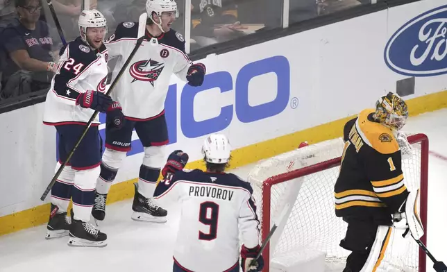 Columbus Blue Jackets right wing Mathieu Olivier (24) is congratulated after his goal against Boston Bruins goaltender Jeremy Swayman (1) during the first period of an NHL hockey game, Monday, Nov. 18, 2024, in Boston. (AP Photo/Charles Krupa)