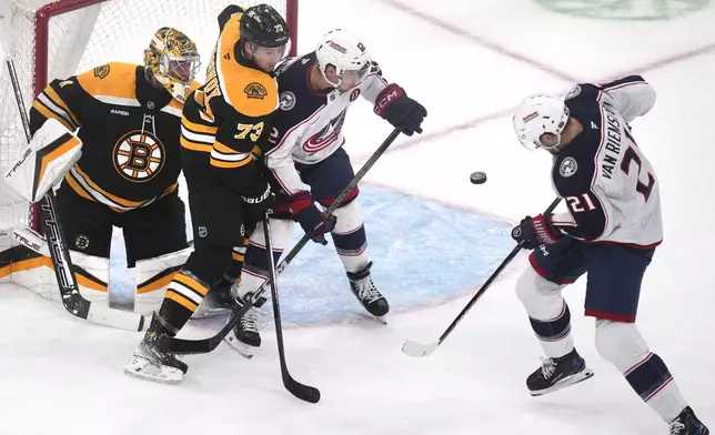 Columbus Blue Jackets left wing James van Riemsdyk (21) deflects a shot by teammate Zach Werenski (not shown) toward the net for a goal against Boston Bruins goaltender Jeremy Swayman (1) during the first period of an NHL hockey game, Monday, Nov. 18, 2024, in Boston. (AP Photo/Charles Krupa)