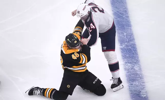 Boston Bruins left wing Jeffrey Viel (48) is dropped to the ice while fighting Columbus Blue Jackets right wing Mathieu Olivier (24) during the first period of an NHL hockey game, Monday, Nov. 18, 2024, in Boston. (AP Photo/Charles Krupa)