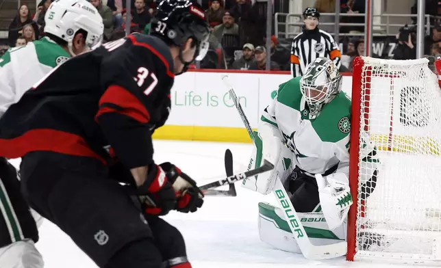 Dallas Stars goaltender Jake Oettinger (29) stops the shot of Carolina Hurricanes' Andrei Svechnikov (37) during the second period of an NHL hockey game in Raleigh, N.C., Monday, Nov. 25, 2024. (AP Photo/Karl B DeBlaker)