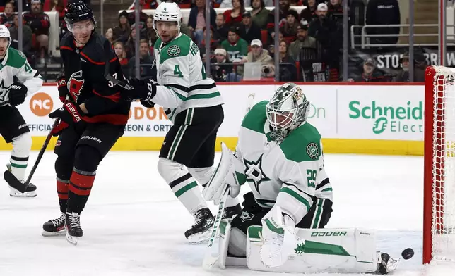 Carolina Hurricanes' Andrei Svechnikov (37) watches as the puck goes wide of Dallas Stars goaltender Jake Oettinger (29) with Miro Heiskanen (4) nearby during the second period of an NHL hockey game in Raleigh, N.C., Monday, Nov. 25, 2024. (AP Photo/Karl B DeBlaker)