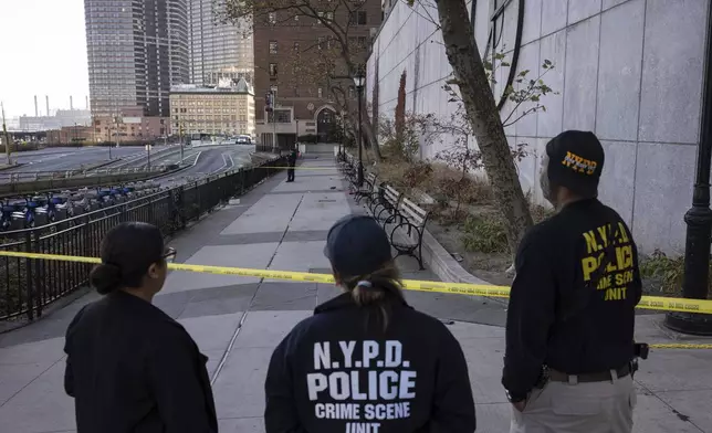 NYPD officers stand at the site of stabbing spree near the United Nations Headquarters in New York, Monday, Nov. 18, 2024. (AP Photo/Yuki Iwamura)