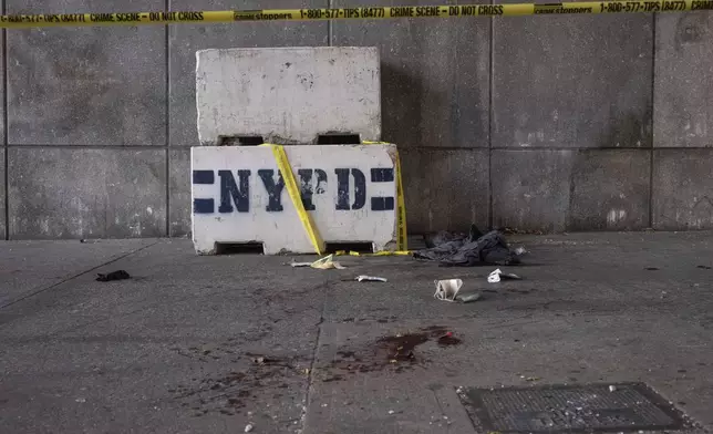 Blood stains the ground at the site of a stabbing spree near the United Nations Headquarters, New York, Monday, Nov. 18, 2024. (AP Photo/Yuki Iwamura)