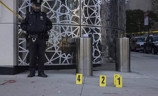 NYPD officers stand at the site where the suspect of a stabbing spree was captured outside Turkish House, New York, Monday, Nov. 18, 2024. (AP Photo/Yuki Iwamura)