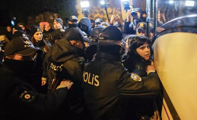 Turkish police officers detain a woman during a protest marking the International Day for the Elimination of Violence Against Women, in Istanbul, Turkey, Monday, Nov. 25, 2024. (AP Photo/Emrah Gurel)