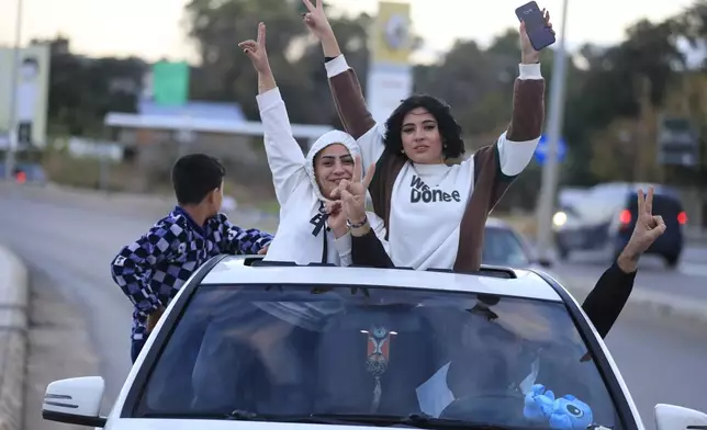 People celebrate after a ceasefire between Israel and Hezbollah went into effect in Sidon, Lebanon, Wednesday, Nov. 27, 2024. (AP Photo/Mohammed Zaatari)